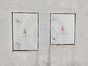 White wall with two doors for electrical distribution grid maintenance entrance