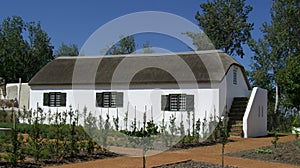 A white wash country cottage with reed roof