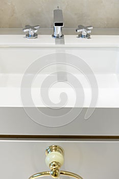 White washbasin with chrome faucet