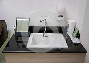 White washbasin and faucet on granite counter