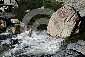 White water due to a boulder altering the river`s flow