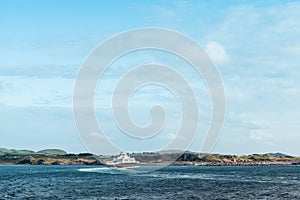 White waterbus in the sea on the Norway countryside background