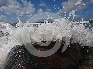 White wave crashed to the huge stone