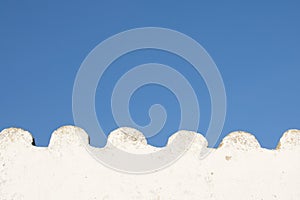 White wavy empty wall in blue sky with copy space