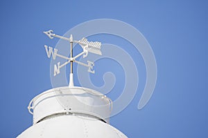 White weather vane on the roof