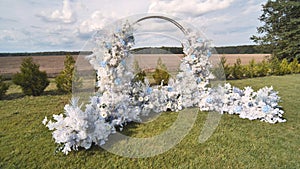 White wedding arch with chairs before the ceremony.