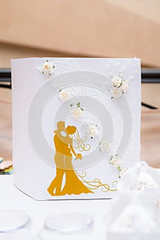 White wedding book, decorated with flowers and lace.