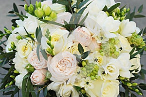 White Wedding Bouquet Roses Pink flowers and Ruscus Leaves with Robbons on Gray Asphalt Background. Wedding Decoration