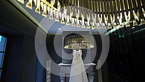 White wedding bridal dress near fireplace in luxury hotel interior