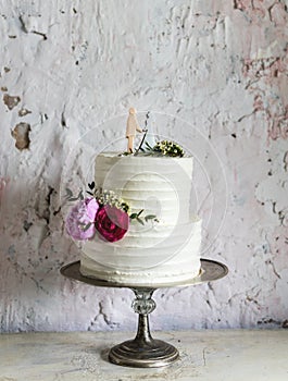 White Wedding Cake with Bride and Groom Figure Topper
