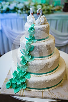 White wedding cake decorated by flowers fruits