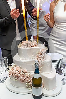 White wedding cake with sparklers