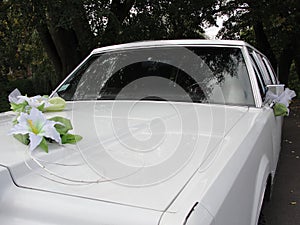 White wedding car with flowers
