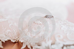 White Wedding dress on bed sheet close-up