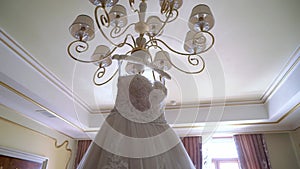 White wedding dress gown of the bride in bedroom