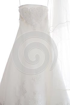 A white wedding dress hanging