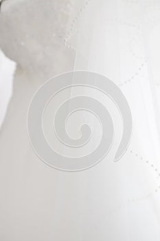 A white wedding dress hanging