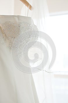 A white wedding dress hanging