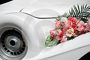 White wedding limousine with flowers