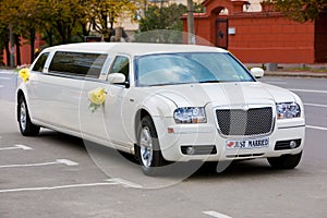 White wedding limousine on the road