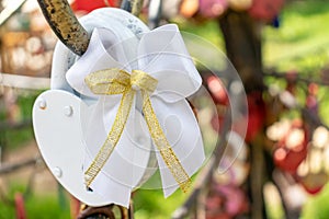 White wedding lock, castle close up on a wedding tree as a symbol of eternal love and happiness