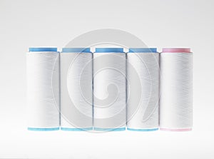 White on white, spools of thread on white background