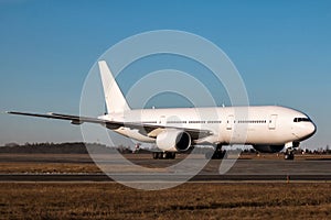 White wide body passenger aircraft taxiing on the main taxiway