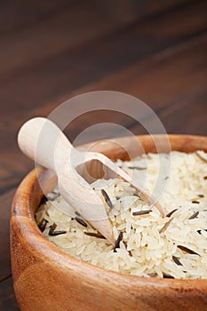 White and wild rice in wooden bowl on table