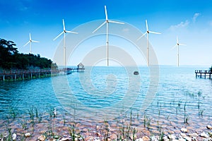 white wind turbine generating electricity