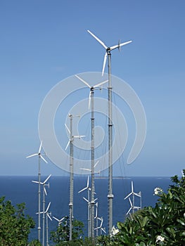 white wind turbine generating electricity on sea