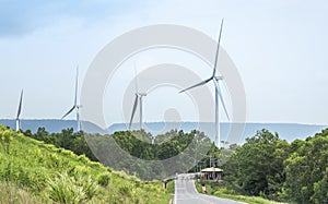 White wind turbines generating electricity in wind power station