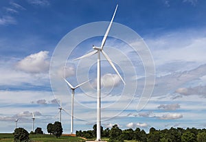 White wind turbines generating electricity in wind power station alternative renewable energy from nature