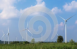 White wind turbines in wind power station alternative renewable energy from nature