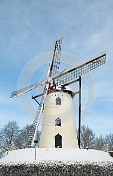 White Windmill on hill in snow