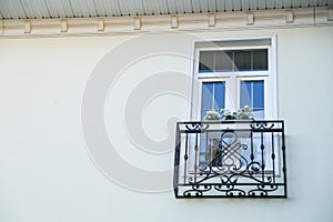 White window with black wrought iron sill