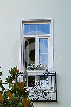 White window with black wrought iron sill