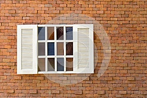 White window with old red brick wall