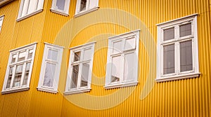 White windows on a yellow facade