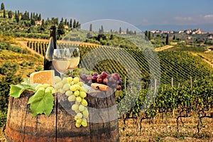 White wine with barrel on vineyard in Chianti, Tuscany, Italy