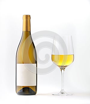 White wine bottle with blank label and wine goble