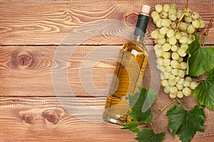 White wine bottle and bunch of white grapes