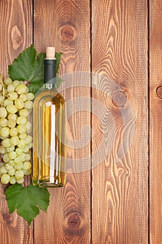 White wine bottle and bunch of white grapes