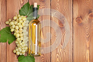 White wine bottle and bunch of white grapes