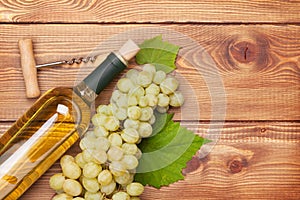 White wine bottle and bunch of white grapes