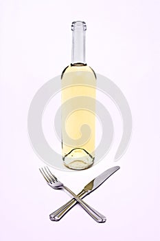 White wine bottle with crossed knife and fork