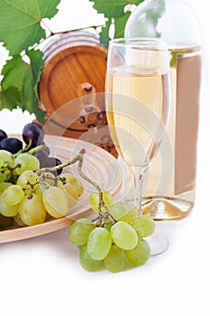 White wine bottle, glass and cask with grapes