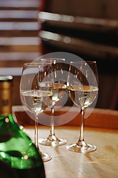 White wine bottle and glasses on wine cask