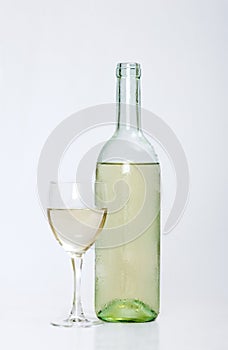 White wine bottle with half filled glass photo