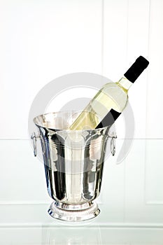 White wine bottle in ice bucket