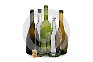 White wine bottle and white oval vodka bottle near green wine bottle, brown wine bottles isolated on white background and wine cor